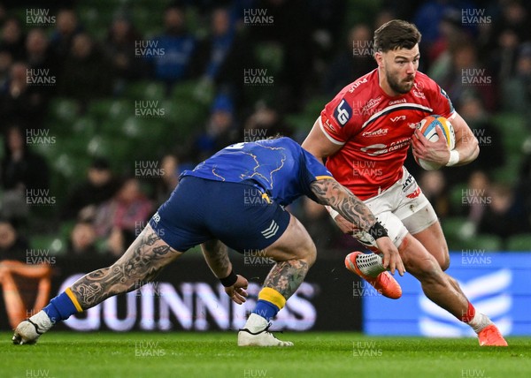270326 - Leinster v Scarlets - United Rugby Championship - Johnny Williams of Scarlets is tackled by Andrew Porter of Leinster