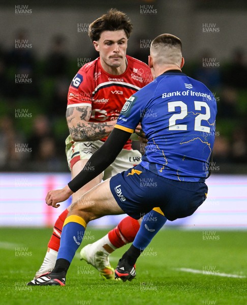 270326 - Leinster v Scarlets - United Rugby Championship - Joe Roberts of Scarlets is tackled by Sam Prendergast of Leinster 