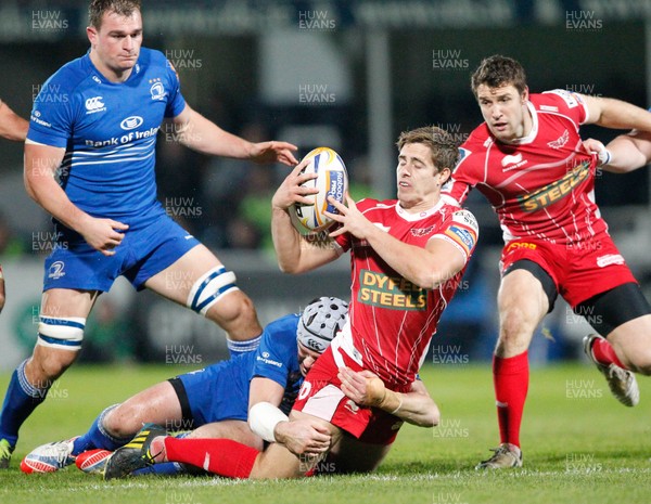 30/11/13 - Leinster v Scarlets - RaboDirect Pro 12Aled Thomas of Scarlets is tackled by Shane Jennings of Leinster (c) Huw Evans Picture Agency