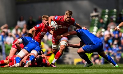 310525 - Leinster v Scarlets - United Rugby Championship Quarter-Final - Taine Plumtree of Scarlets is tackled by Thomas Clarkson of Leinster