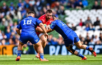 310525 - Leinster v Scarlets - United Rugby Championship Quarter-Final - Kemsley Mathias of Scarlets is tackled by Dan Sheehan, right, and Rabah Slimani of Leinster
