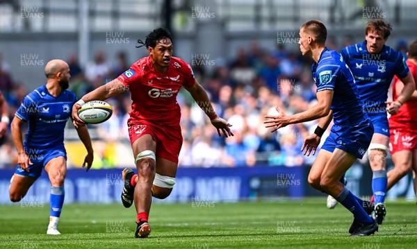 310525 - Leinster v Scarlets - United Rugby Championship Quarter-Final - Sam Lousi of Scarlets in action against Sam Prendergast of Leinster
