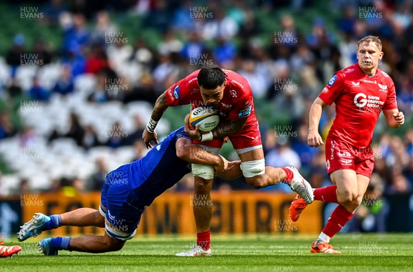 310525 - Leinster v Scarlets - United Rugby Championship Quarter-Final - Vaea Fifita of Scarlets is tackled by Scott Penny of Leinster