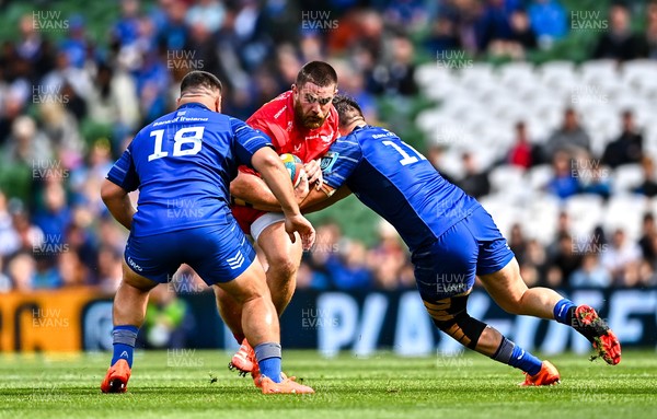 310525 - Leinster v Scarlets - United Rugby Championship Quarter-Final - Kemsley Mathias of Scarlets is tackled by Dan Sheehan, right, and Rabah Slimani of Leinster