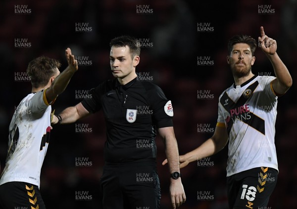 121220 - Leyton Orient v Newport County - Sky Bet League 2 - Scott Twine of Newport County and Jamie Proctor pressure Referee Tom Nield as Tristan Abrahams' goal is disallowed