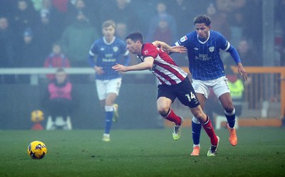 201225 - Lincoln City v Cardiff City - Sky Bet League 1 - Omari Kellyman of Cardiff and Conor McGrandles of Lincoln