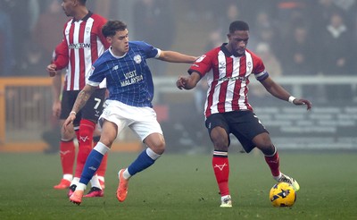 201225 - Lincoln City v Cardiff City - Sky Bet League 1 - Alex Robertson of Cardiff and Tendayi Darikwa of Lincoln