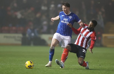 201225 - Lincoln City v Cardiff City - Sky Bet League 1 - Will Fish of Cardiff and Justin Obikwu of Lincoln