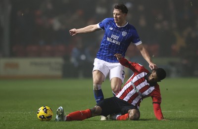 201225 - Lincoln City v Cardiff City - Sky Bet League 1 - Will Fish of Cardiff and Justin Obikwu of Lincoln