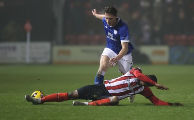 201225 - Lincoln City v Cardiff City - Sky Bet League 1 - Will Fish of Cardiff and Justin Obikwu of Lincoln