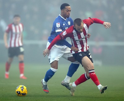 201225 - Lincoln City v Cardiff City - Sky Bet League 1 - Chris Willock of Cardiff tackles Tom Hamer of Lincoln