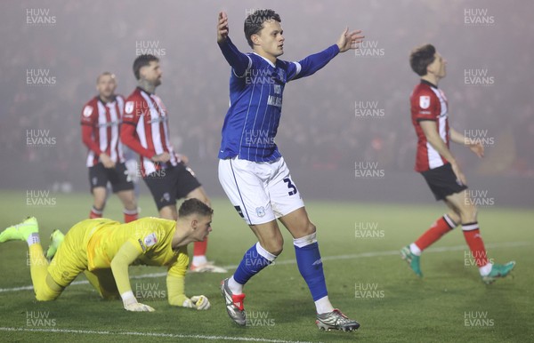 201225 - Lincoln City v Cardiff City - Sky Bet League 1 - Perry Ng of Cardiff celebrates 1st Cardiff goal in 2nd half as Goalkeeper George Wickens of Lincoln is floored