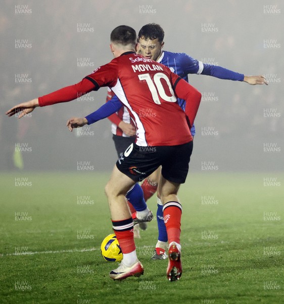 201225 - Lincoln City v Cardiff City - Sky Bet League 1 - Perry Ng of Cardiff tries to pass Jack Moylan of Lincoln in the goal mouth