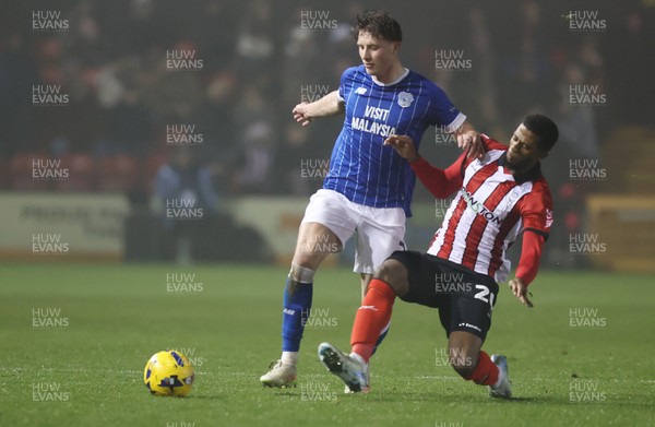 201225 - Lincoln City v Cardiff City - Sky Bet League 1 - Will Fish of Cardiff and Justin Obikwu of Lincoln