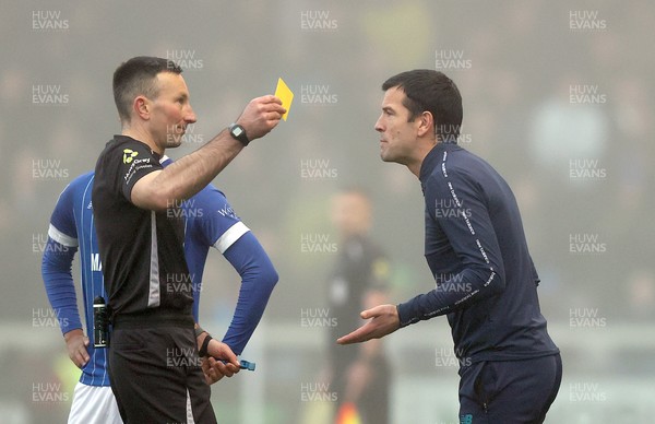 201225 - Lincoln City v Cardiff City - Sky Bet League 1 - Referee Richard Eley shows Manager Brian Barry-Murphy of Cardiff a yellow card in the 1st half