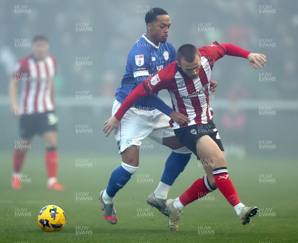 201225 - Lincoln City v Cardiff City - Sky Bet League 1 - Chris Willock of Cardiff tackles Tom Hamer of Lincoln
