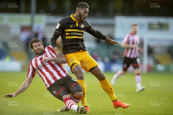 221218 - Lincoln City v Newport County - Sky Bet League 2 - Lincoln's Michael Bostwick up against Jamille Matt