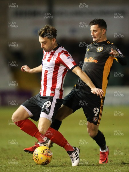 300118 - Lincoln City v Newport County, Sky Bet League 2 - Padraig Amond of Newport County and Lee Frecklington of Lincoln City compete for the ball