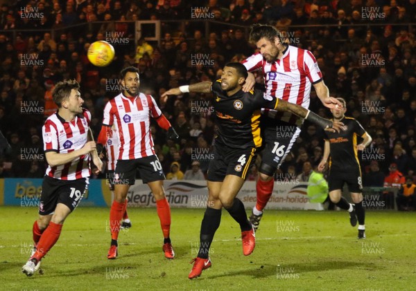 300118 - Lincoln City v Newport County, Sky Bet League 2 - Michael Bostwick of Lincoln City puts Joss Labadie of Newport County under pressure as they compete for the ball