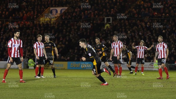 300118 - Lincoln City v Newport County, Sky Bet League 2 - Padraig Amond of Newport County leaves the Lincoln City players dumbfounded as he wheels away to celebrate after scoring goal