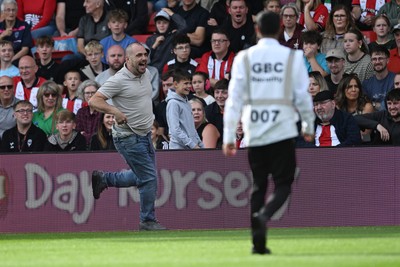 190926 - Lincoln City v Swansea City - Sky Bet Championship - A Lincoln City supporter invades the pitch