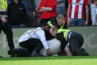190926 - Lincoln City v Swansea City - Sky Bet Championship - A Lincoln City supporter invades the pitch