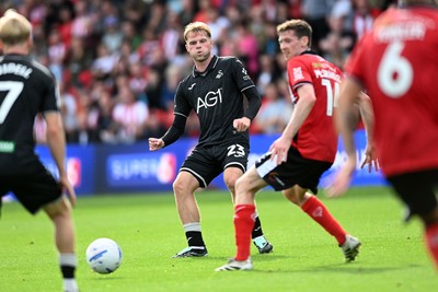 190926 - Lincoln City v Swansea City - Sky Bet Championship - Stephen Welsh of Swansea City is challenged by Conor McGrandles of Lincoln
