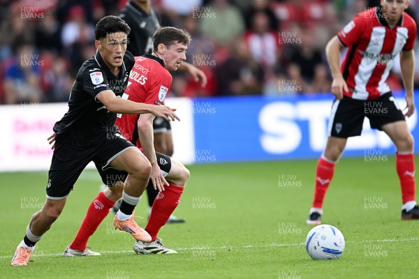 190926 - Lincoln City v Swansea City - Sky Bet Championship - Elijah Just of Swansea City is challenged by Conor McGrandles of Lincoln