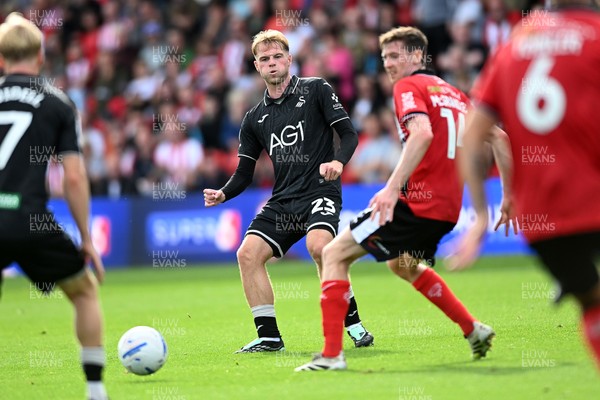 190926 - Lincoln City v Swansea City - Sky Bet Championship - Stephen Welsh of Swansea City is challenged by Conor McGrandles of Lincoln