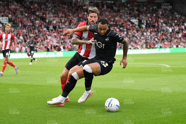 190926 - Lincoln City v Swansea City - Sky Bet Championship - Adam Idah of Swansea City is challenged by Sonny Bradley of Lincoln