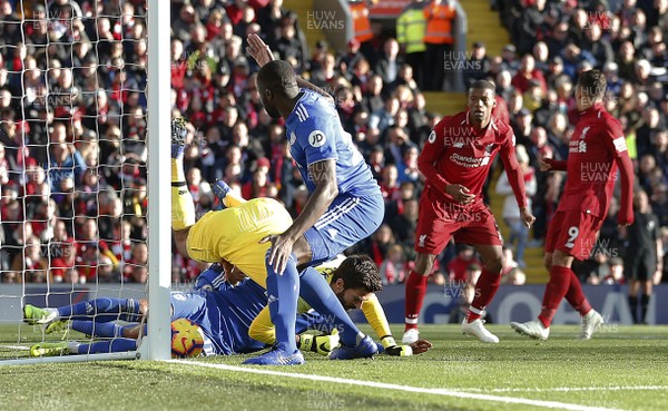271018 - Liverpool v Cardiff - Premier League -  Sol Bamba of Cardiff and Josh Murphy of Cardiff tangled with Alisson Becker of Liverpool try to score in 2nd half but goal not given
