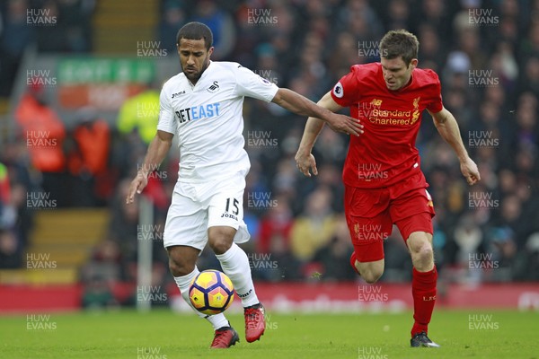 210117 - Liverpool v Swansea City, Premier League - Wayne Routledge of Swansea City (left) evades the tackle of James Milner of Liverpool by Ian Smith/Huw Evans Agency