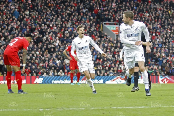 210117 - Liverpool v Swansea City, Premier League - Gylfi Sigurdsson of Swansea City (right) celebrates scoring his side's third goal