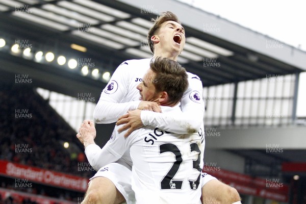 210117 - Liverpool v Swansea City, Premier League - Gylfi Sigurdsson of Swansea City (front) celebrates scoring his side's third goal with Tom Carroll