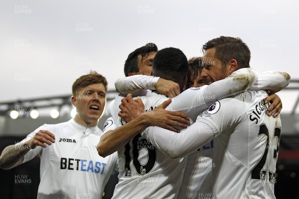 210117 - Liverpool v Swansea City, Premier League - Gylfi Sigurdsson of Swansea City (right) celebrates scoring his side's third goal with team-mates