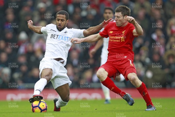 210117 - Liverpool v Swansea City, Premier League - Wayne Routledge of Swansea City (left) pulls the ball back as James Milner of Liverpool closes in by Huw Evans Agency