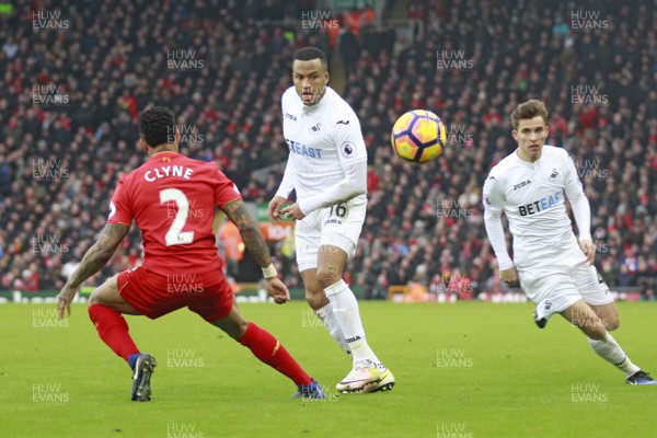 210117 - Liverpool v Swansea City, Premier League - Martin Olsson of Swansea City (centre) passes despite the attentions of Nathaniel Clyne of Liverpool (left) by Huw Evans Agency