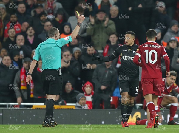 261217 - Liverpool v Swansea City - Premier League - Martin Olsson of Swansea gets a yellow card from referee Kevin Friend