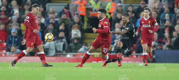 261217 - Liverpool v Swansea City - Premier League - Kyle Naughton of Swansea tries a shot on goal past Alex Oxlade-Chamberlain of Liverpool and Roberto Firmino of Liverpool