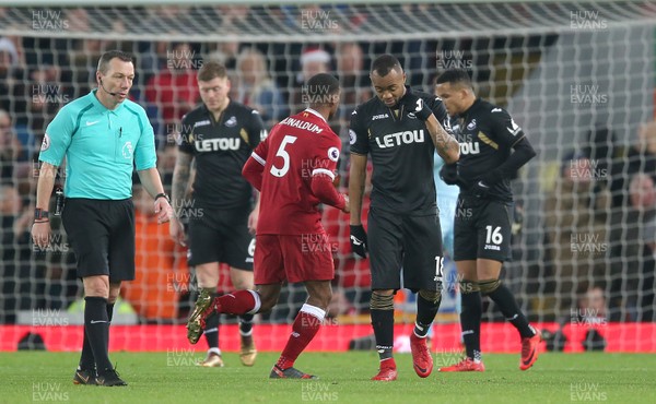 261217 - Liverpool v Swansea City - Premier League - Jordan Ayew of Swansea ,Martin Olsson of Swansea and Alfie Mawson of Swansea walk back towards centre after 3rd goal261217 - Liverpool v Swansea City - Premier League - Swansea players led by Martin Olsson of Swansea walk to the centre circle to continue play after a Liverpool goal