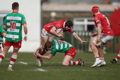 250323 - Llandovery v Llanelli - Indigo Group Premiership - Harrison Button of Llanelli is tackled by Aaron Warren of Llandovery