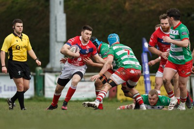 250323 - Llandovery v Llanelli - Indigo Group Premiership - Rhys Harris of Llanelli takes on Stuart Worrall of Llandovery