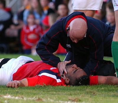 060903 - Llanelli Scarlets v Newport Gwent Dragons - Celtic League - Scarlets' medical staff check injured Salesi Finau's airways after being high tackled