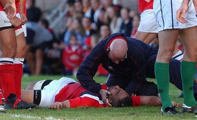 060903 - Llanelli Scarlets v Newport Gwent Dragons - Celtic League - Scarlets' medical staff treat injured Salesi Finau