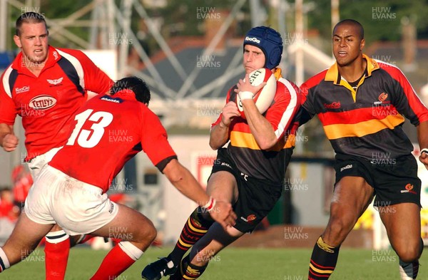 060903 - Llanelli Scarlets v Newport Gwent Dragons - Celtic League - Dragons' Craig Warlow tries to run around Tal Selley