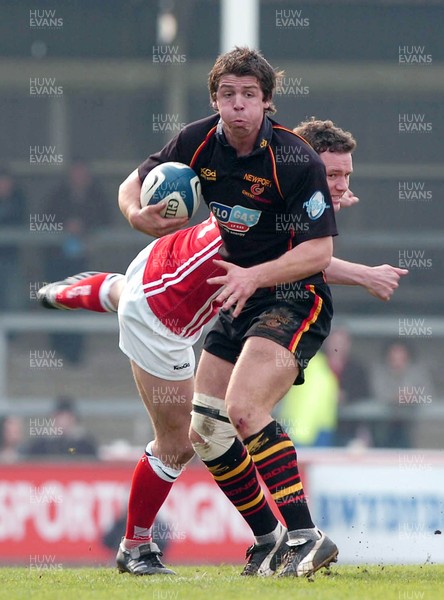 220406 - Llanelli Scarlets v Newport Gwent Dragons - Celtic League -  Dragons James Ireland gets away from Mark Jones