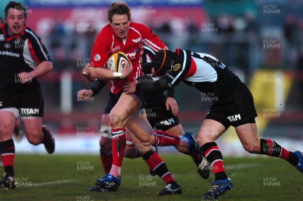 030307 - Llanelli Scarlets v Ulster - Magners League - Llanelli's Matthew Watkins is tackled by David Humphreys 