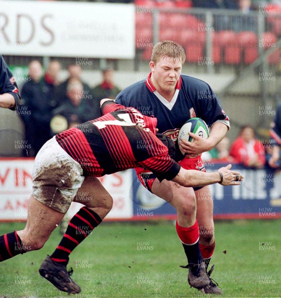 030499 - Llanelli v Aberavon - Phil Booth of Llanell is tackled by Howard Merritt 