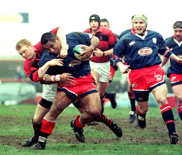 030499 - Llanelli v Aberavon - Salesi Finau is tackled by Darren Griffiths 