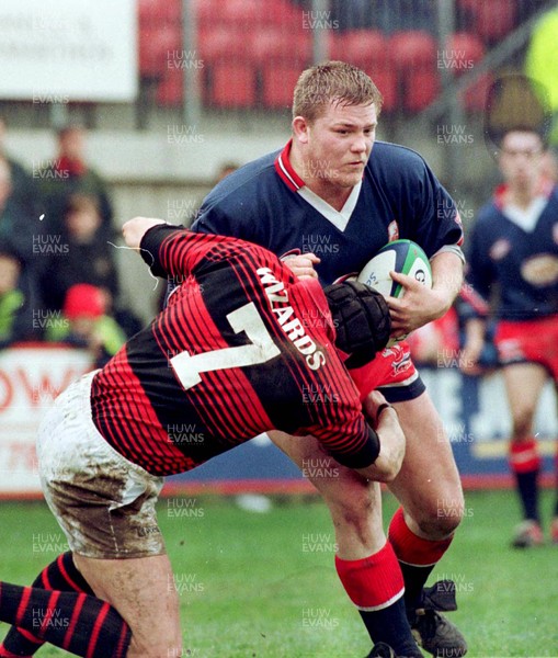 030499 - Llanelli v Aberavon - Phil Booth of Llanelli is tackled by Howard Merritt 